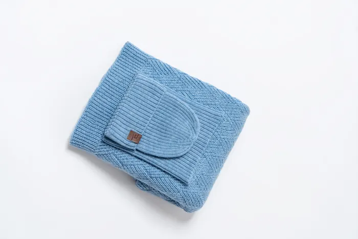 Light-blue beanie and scarf set flat lay