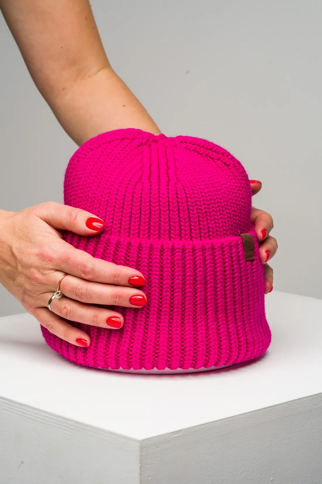 Fuchsia knitted beanie fresh from the BerryBoat mill — chunky rib, leather patch